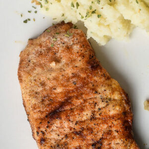 seared chicken over garlic herb mashed potatoes